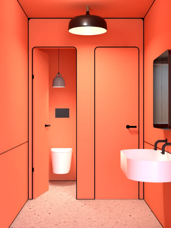 Toiletten im Swingerclub mit oranger Wandfarbe und Terrazzo-Boden